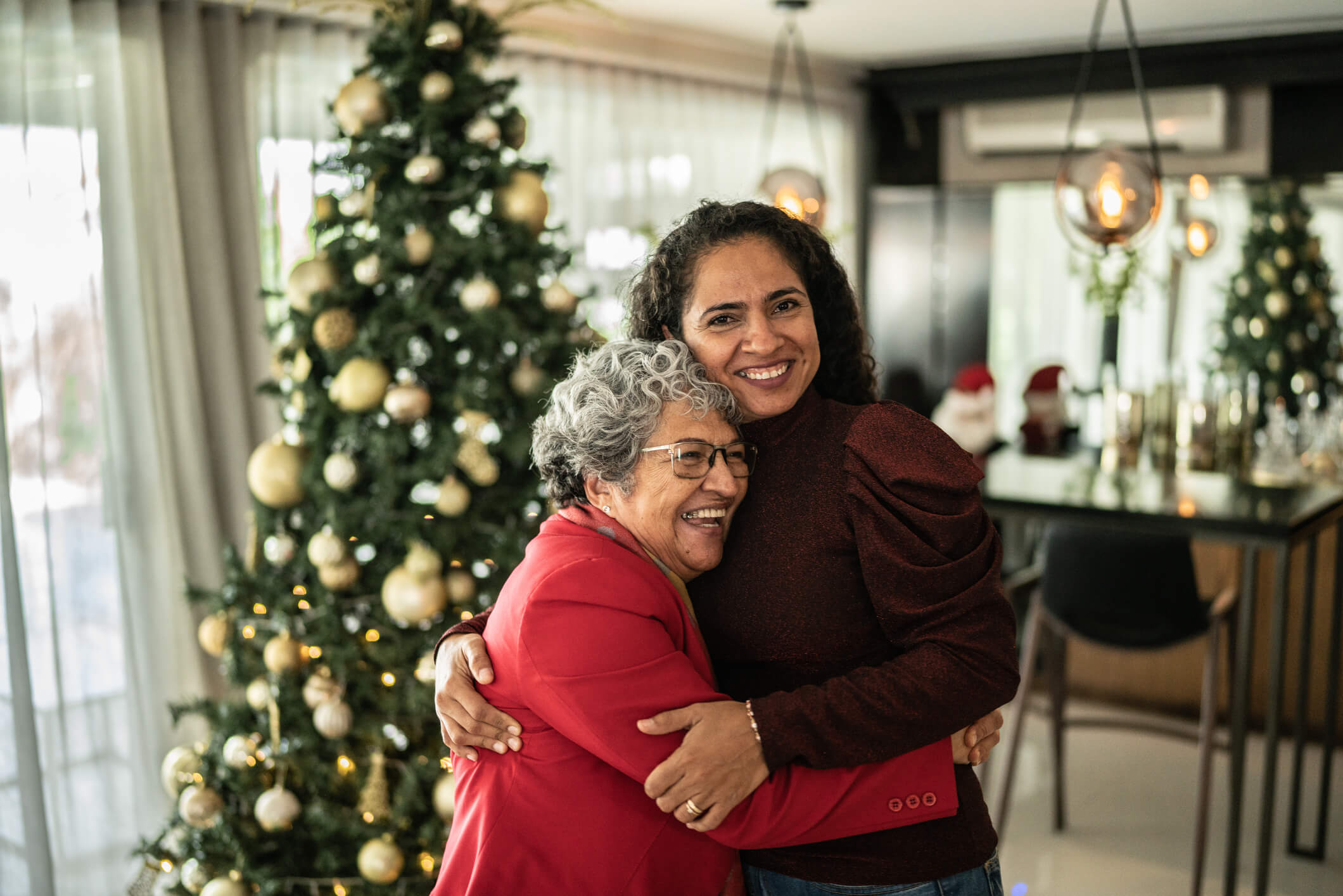 Two women hugging at Christmas time